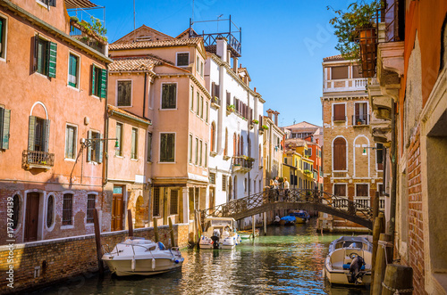 Traditional narrow canal with gondolas in Venice, Italy © Olena Zn