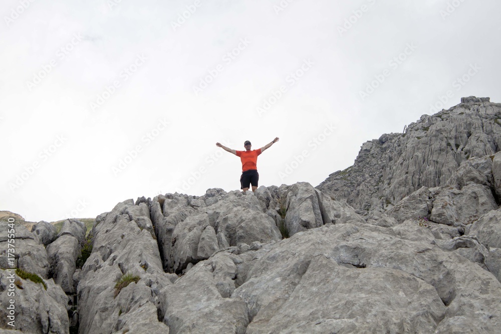 hiker in the high of a rock in Pyrenees, Spain