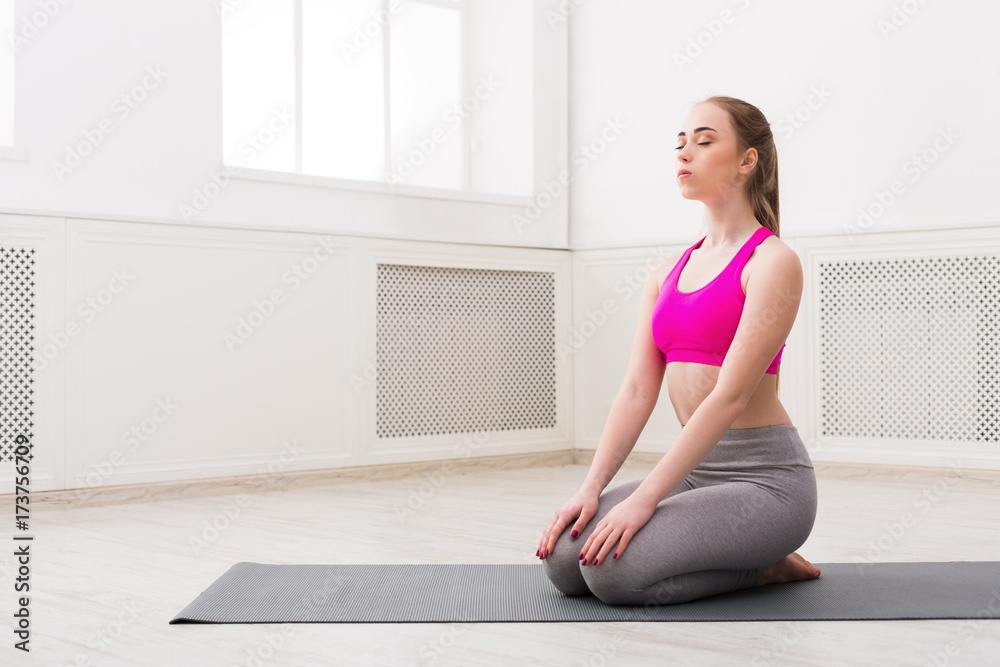 Woman training yoga in hero pose. Woman training yoga in hero pose.
