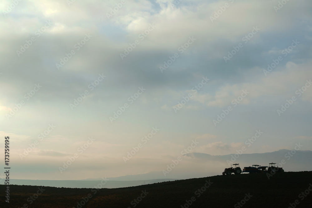 Farmer in tractor preparing land with seedbed cultivator Farmer in tractor preparing land with seedbed cultivator
