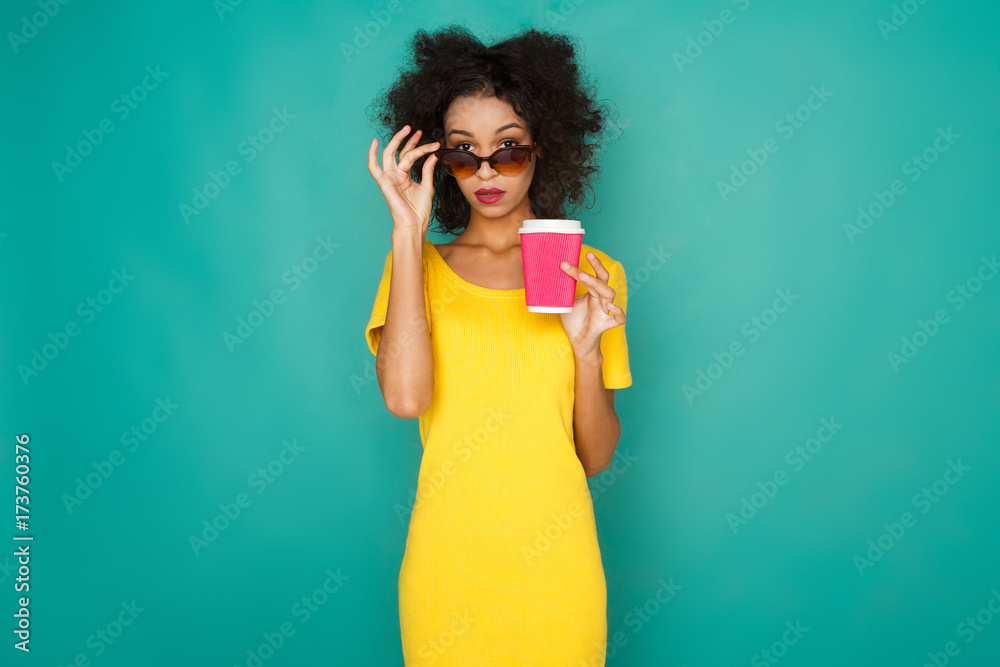 Happy girl drinking coffe at studio background Happy girl drinking coffe at studio background