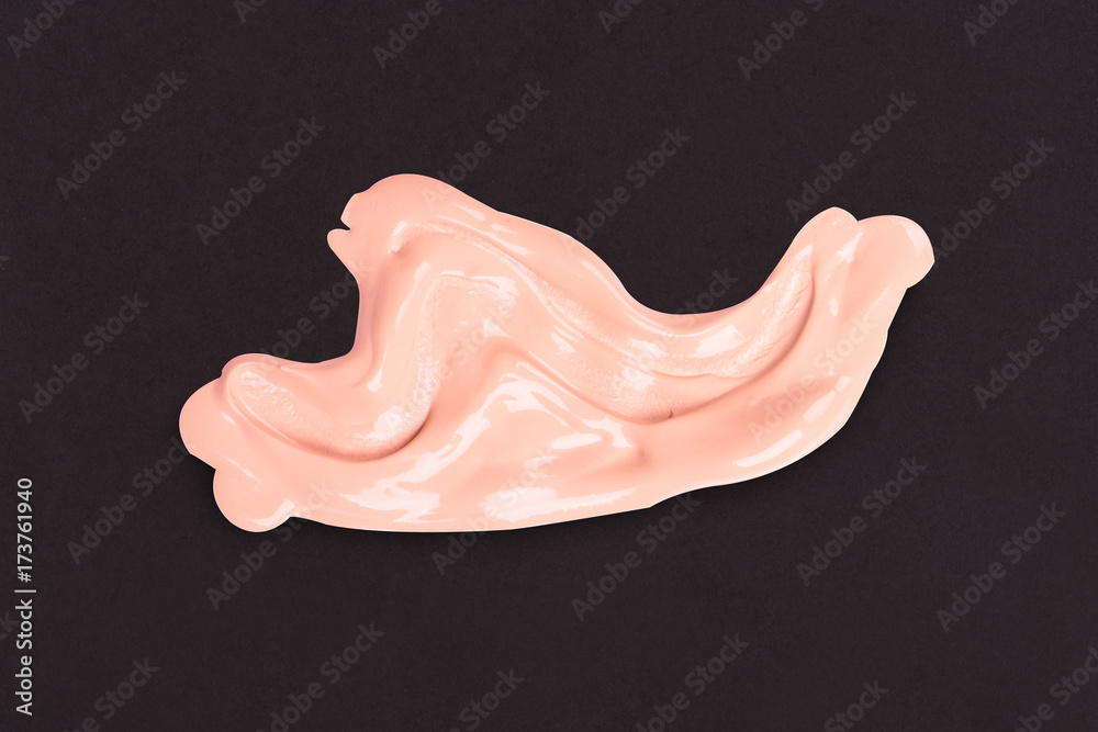 Fototapeta premium Liquid makeup foundations smear drop on black background.