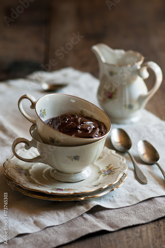 a tea cup full with a chocolate cream photo