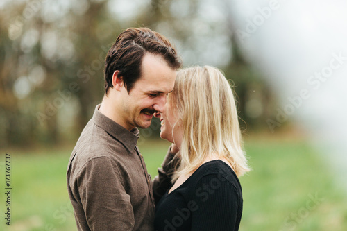 A young hipster couple giggling together photo