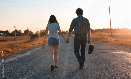 man and a girl are walking in the autumn