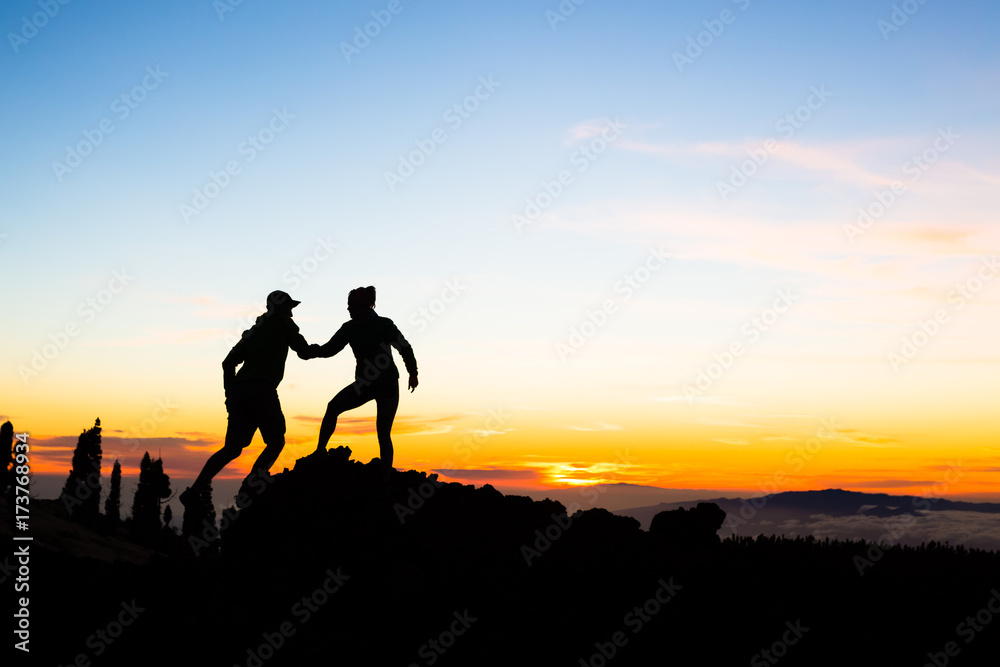 Teamwork couple climbing with helping hand