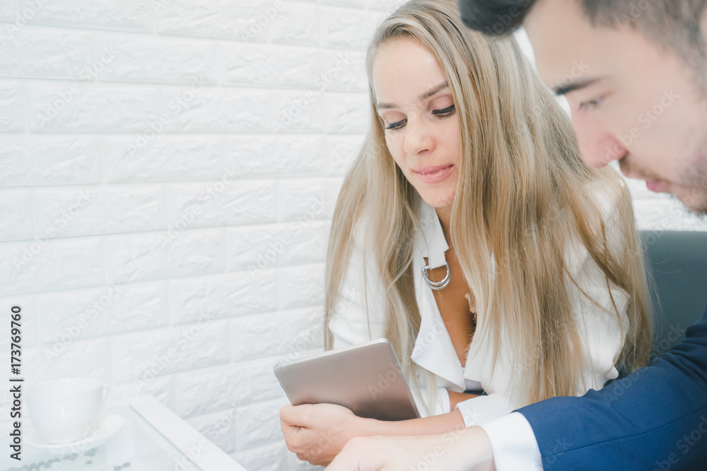 Professional businessman and businesswoman discussing together in the office, businessman look at document Professional businessman and businesswoman discussing together in the office, businessman look at document