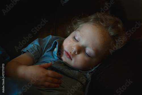young boy sleeping on couch