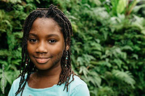 Portrait of smiling girl in tropical forest