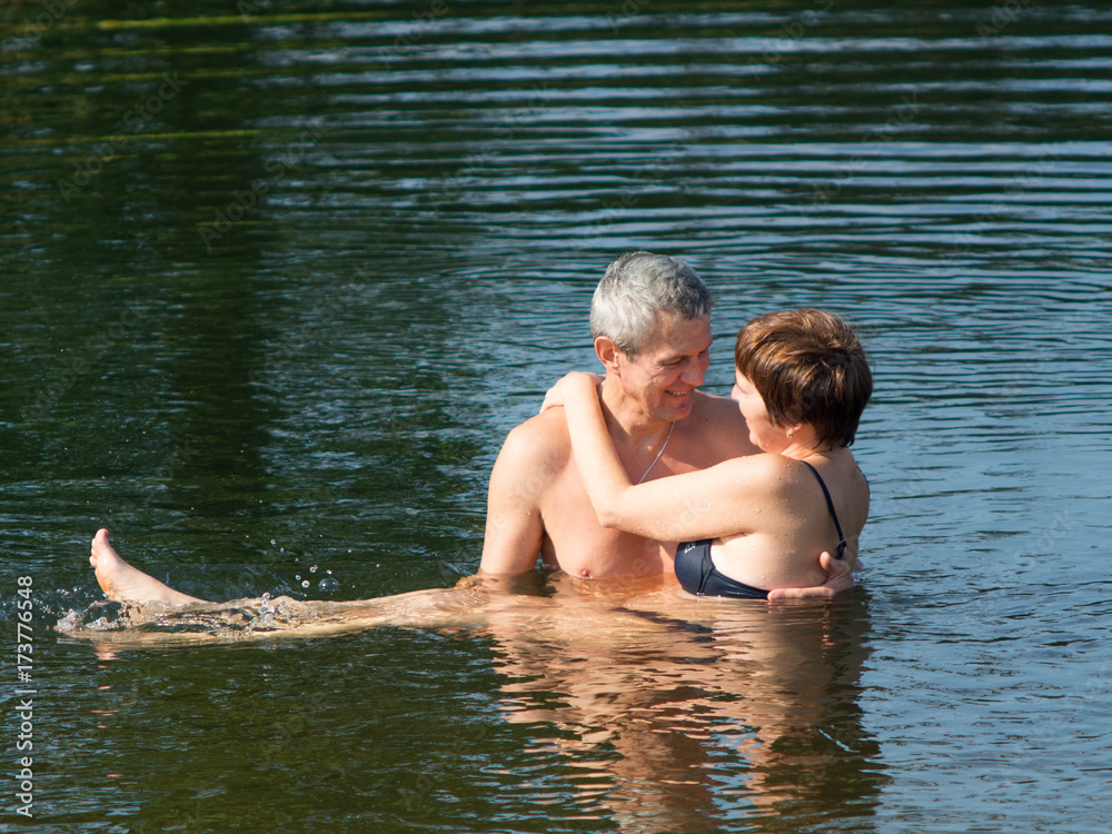 man holding woman on water