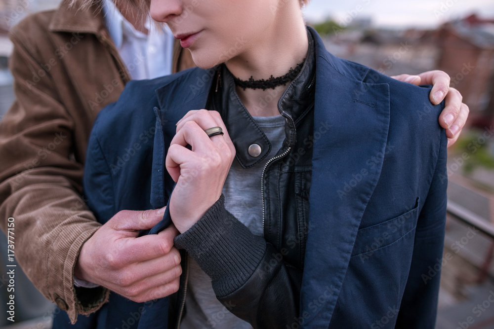 Close up of young couple takes care each other on urban city background. Meeting on roof, tenderness and romance, happiness and love concept Close up of young couple takes care each other on urban city background. Meeting on roof, tenderness and romance, happiness and love concept
