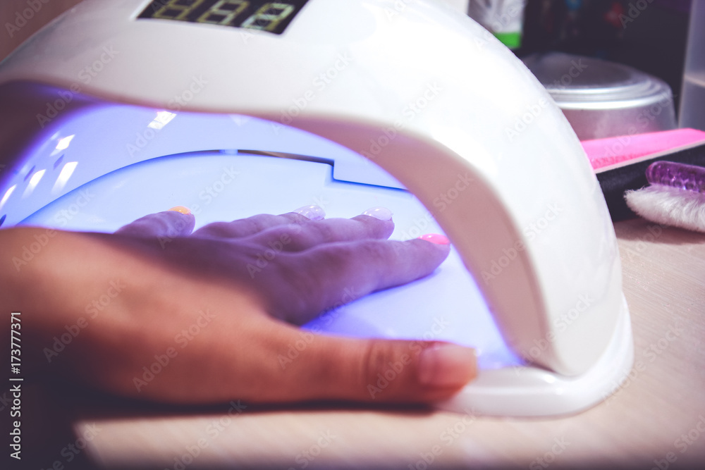 Фотография UV lamp for attaching plastic nails with gel method