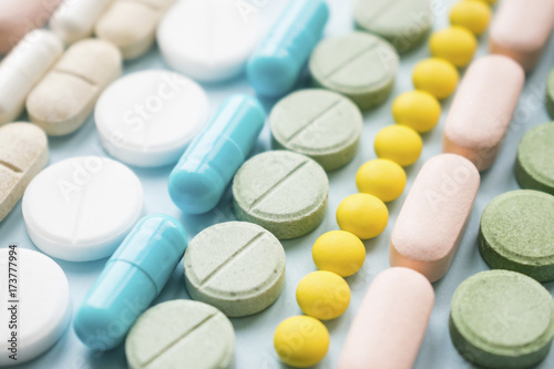 Opioid painkillers crisis and drug abuse concept. Opioid and prescription medication addiction epidemic. Different kinds of multicolored pills. Pharmaceutical medicament background photo