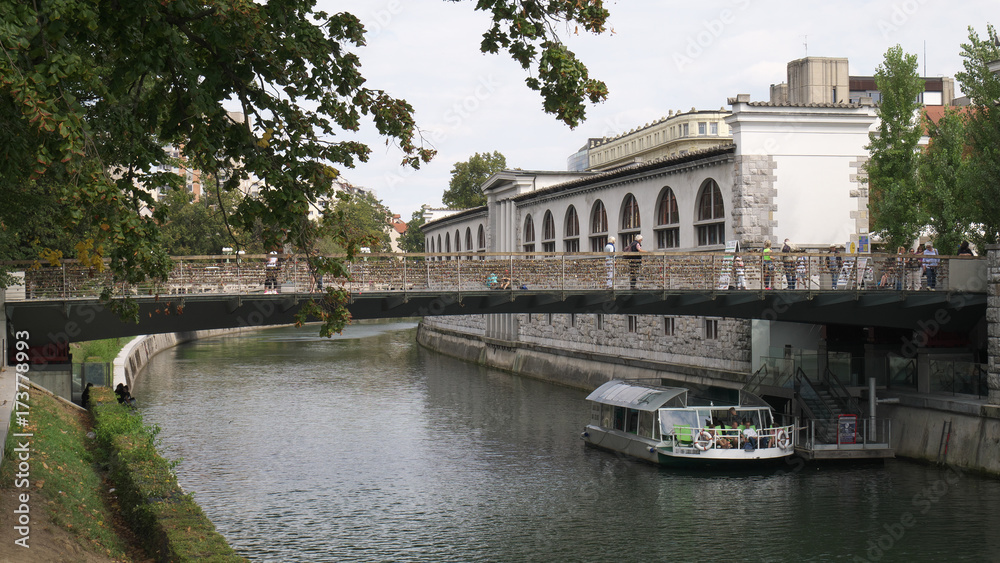 bridge of lovers with locks on rails of the Ljubljanica River