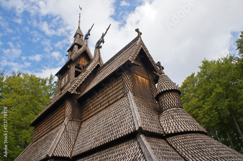 Fantoft Stavkirke - wooden church near Bergen, Norway, surrounded by trees, viking architecture photo