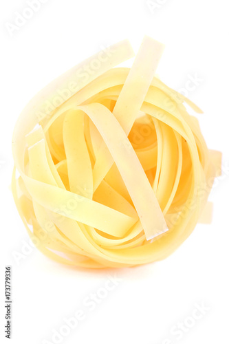 isolated nest of pasta tagliatelle on white background