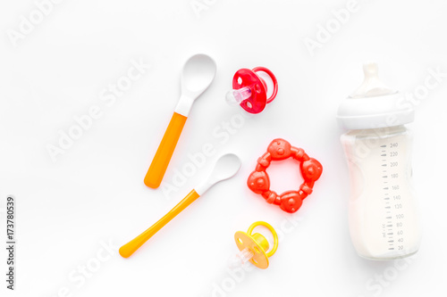 Mother care breast milk in bottle and infant formula powdered healthy food for baby feeding on white background top view