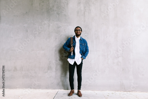 African american man standing in front of a wall. photo