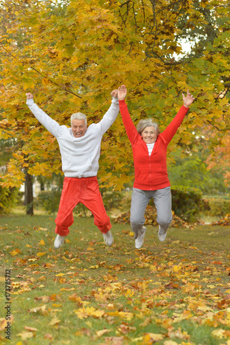 senior couple jumping 