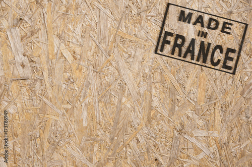 close-up of a brown pressed wood textured box with burn stamp Made in FRANCE on it