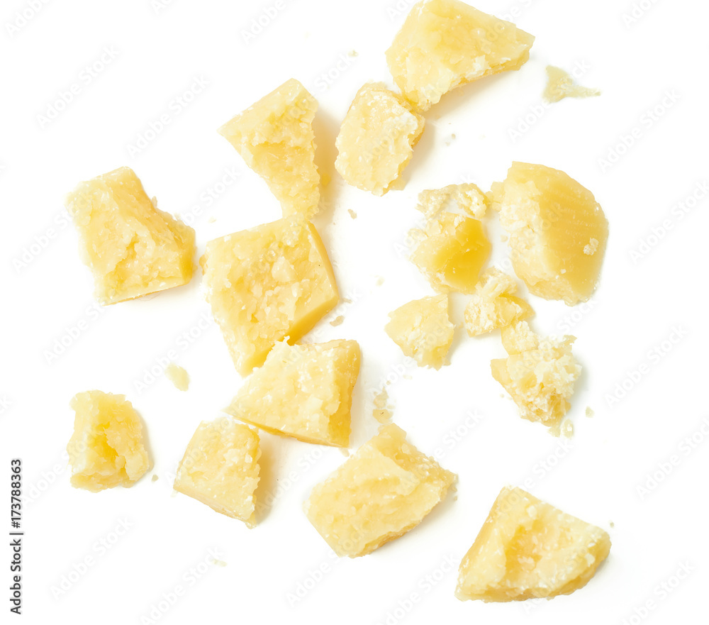 Parmesan cheese pieces on white background. Italian cheese slices. Top view.