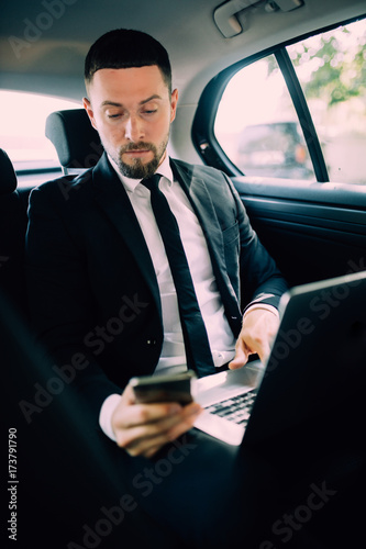 Business Man in rear of the car. Typing text message on cell phone © F8  \ Suport Ukraine