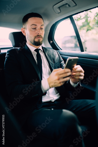 Business Man in rear of the car. Typing text message on cell phone © F8  \ Suport Ukraine