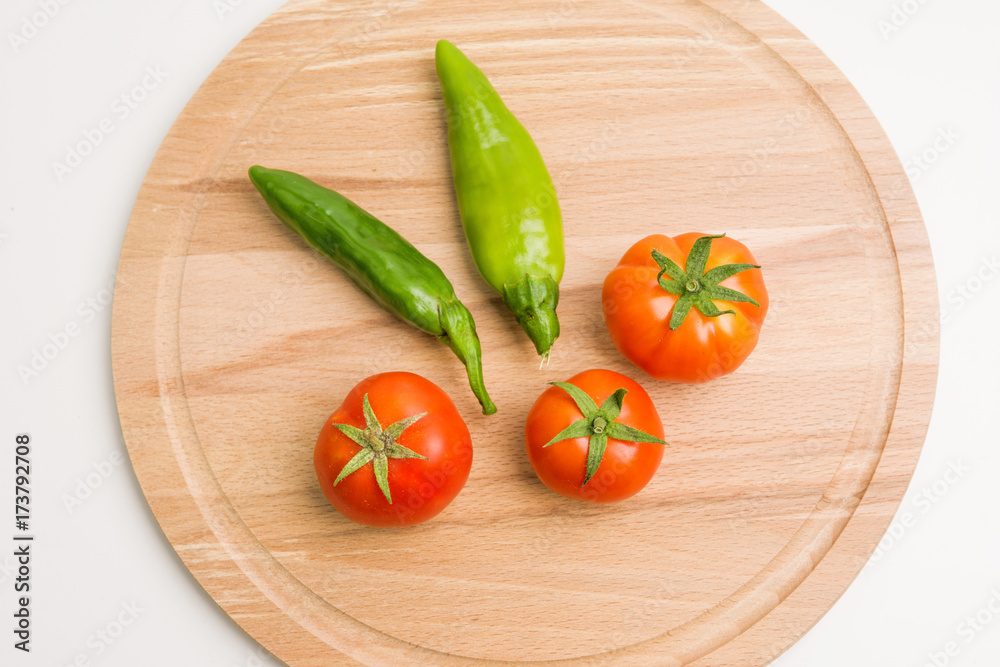 Closeup Of Tomatoes With Hot Green Pepper On Wooden Plate Top View