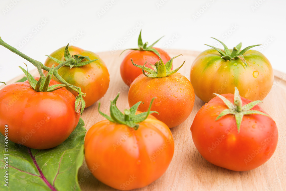 Fresh Tomatoes From The Garden On Wooden Plate Closeup Fresh Tomatoes From The Garden On Wooden Plate Closeup