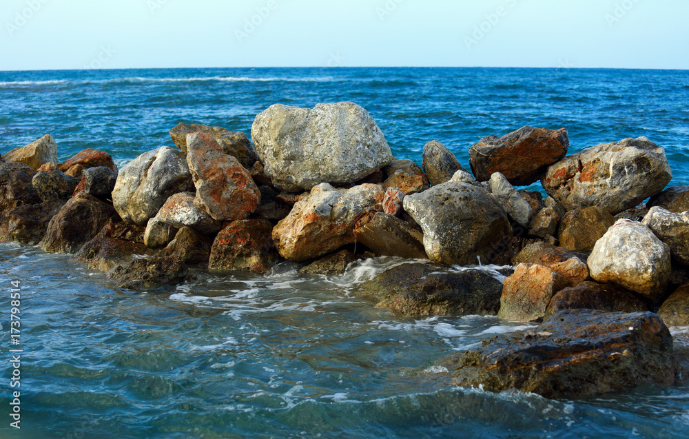 Beautiful sea wave background on the stones near the shore and foam. Contrast portrait