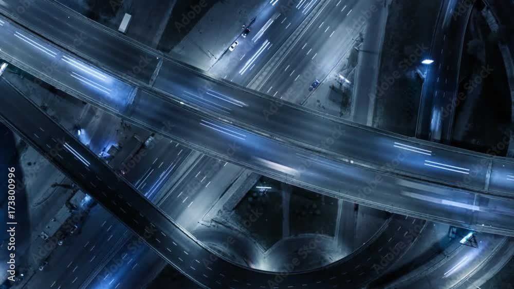 Traffic on freeway interchange. Aerial night view timelapse city traffic.  UHD, 4K