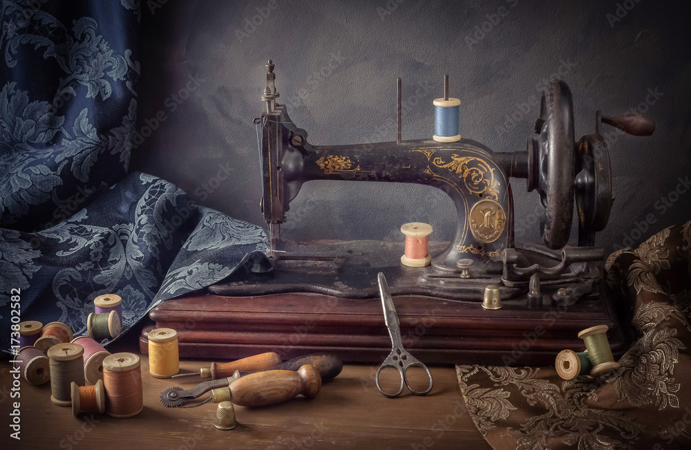 Still life with a sewing machine, scissors, threads