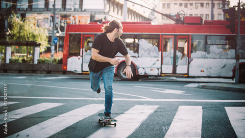 Professional skater riding skate on streets through cars and traffic