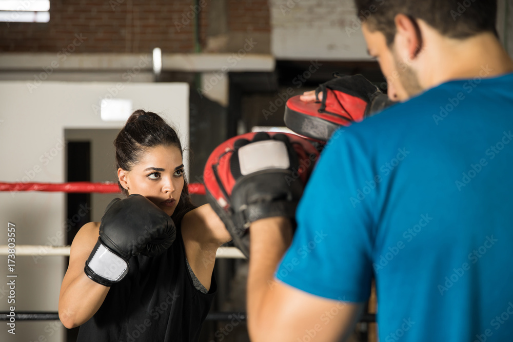 Woman training with boxing gloves in a gym Woman training with boxing gloves in a gym