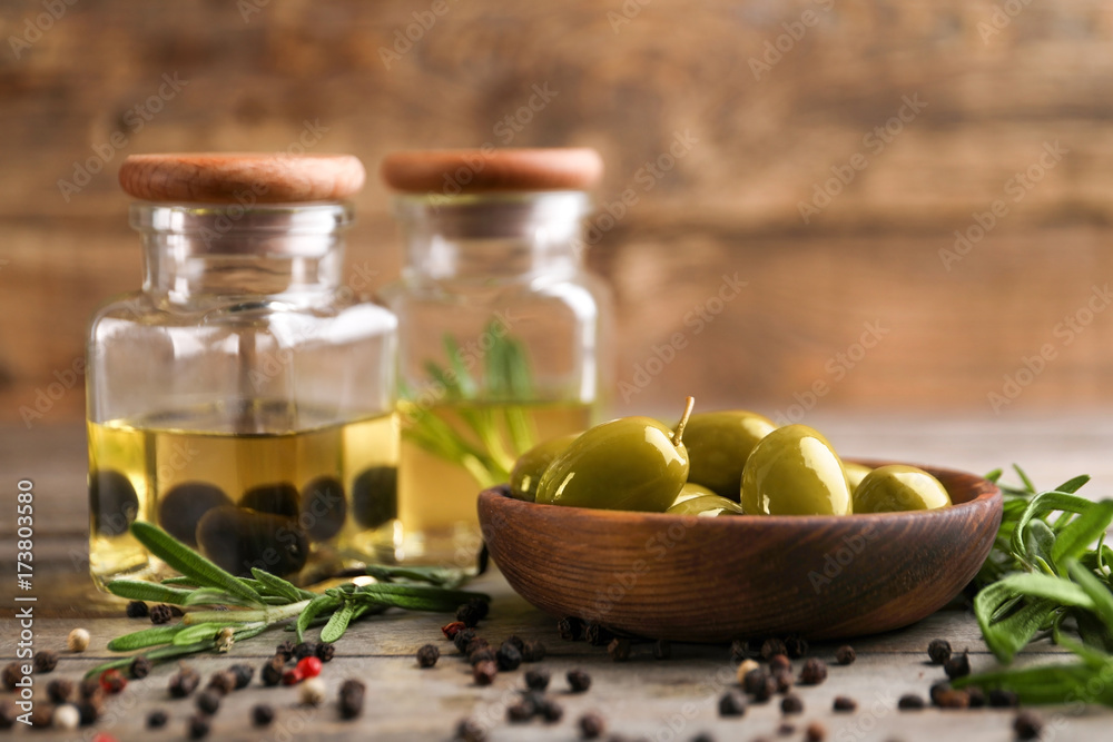 Composition with healthy olives and oil on wooden table Composition with healthy olives and oil on wooden table