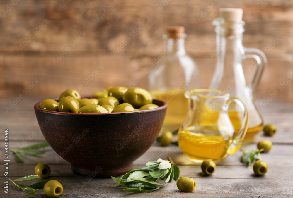 Bowl with olives on wooden table Bowl with olives on wooden table