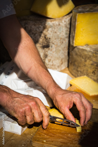 Cheese cutting in a food market