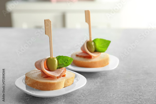 Delicious canapes for baby shower on plates