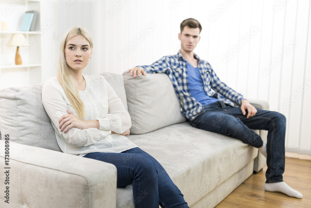 The unhappy woman sit near the man on the sofa The unhappy woman sit near the man on the sofa