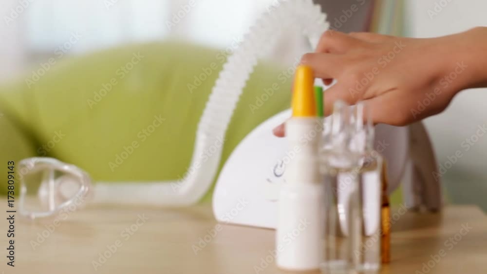 Hand turning on nebuliser inhaler device with vapor being generated - rack focus, camera dolly Hand turning on nebuliser inhaler device with vapor being generated - rack focus, camera dolly