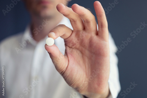 Taking pills. Close-up of man taking medicine.