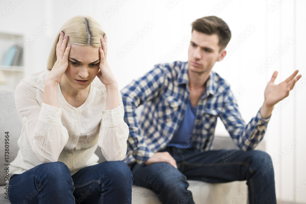 The stressed woman sit near the man