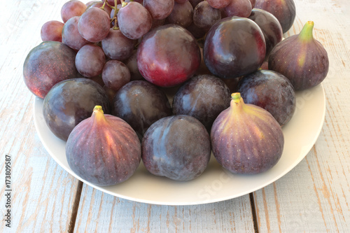 Autumn harvest with grapes, plums, figs, apples. Healthy organic fruit and vegetables. Thanksgiving organic food background.