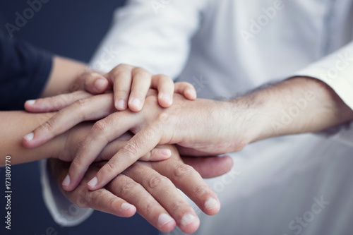 Close-up of boy and child holding hand and supporting each other. Father and son bonds.
