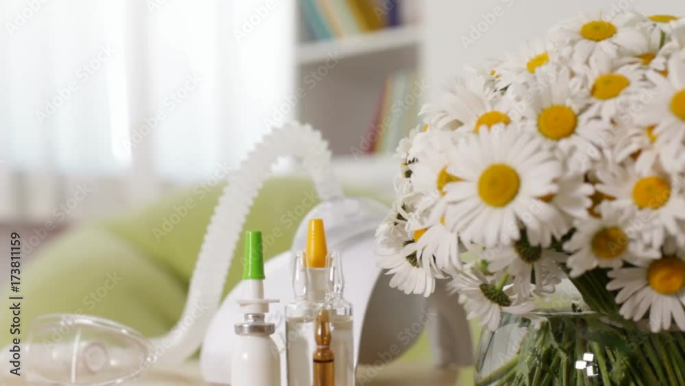 Nebuliser inhaler device revealing from behind daisy bouquet, allergy concept - rack focus, camera dolly Nebuliser inhaler device revealing from behind daisy bouquet, allergy concept - rack focus, camera dolly