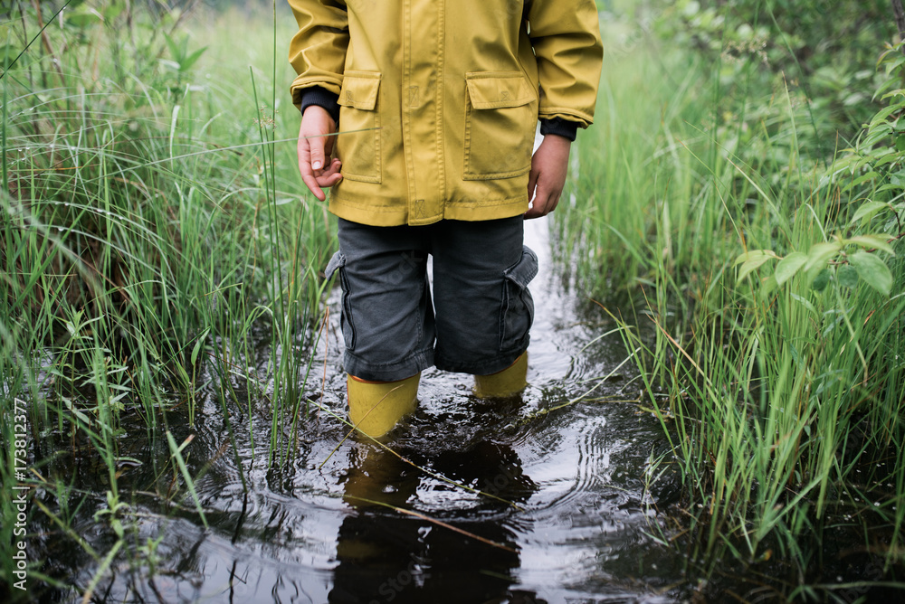 little boy on walk in a flooded path little boy on walk in a flooded path