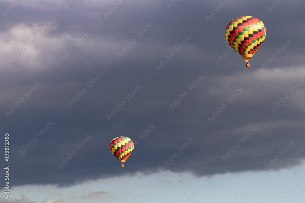 Obraz premium Colorful hot air balloon with puffy clouds in background