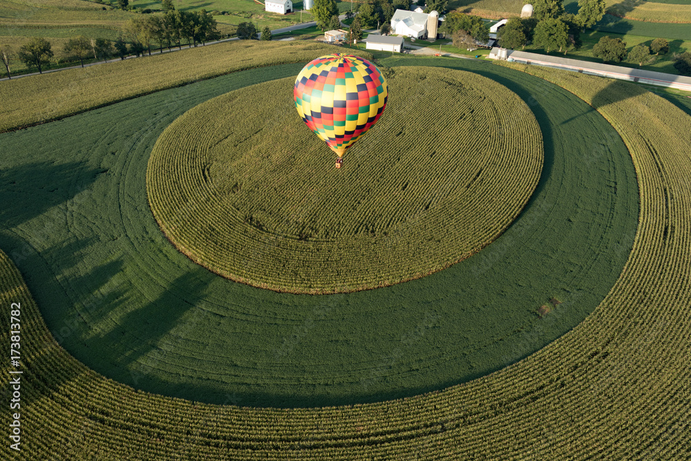 Aerial view of farmland and hot air balloon