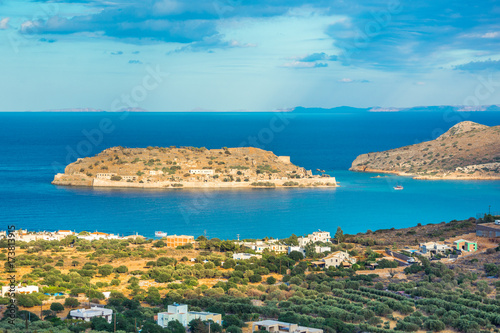 View of the island of Spinalonga at sunset with nice clouds and calm sea. Here were isolated lepers, humans with the Hansen's desease and took place the story of Victoria 's Hislop novel "The Island".