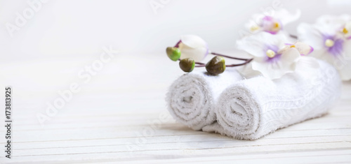 SPA setting with bath towels and orchid flower, selective focus